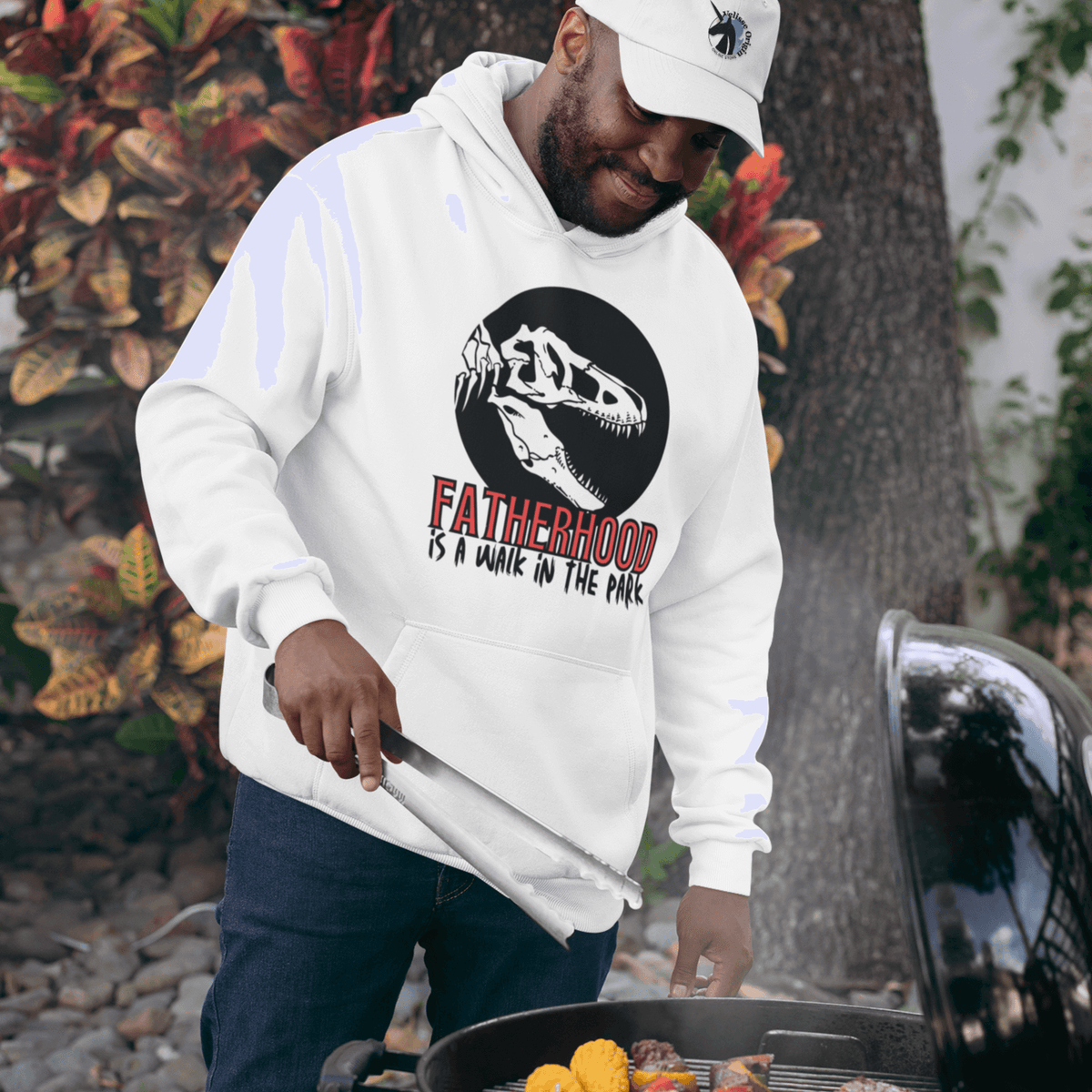 hoodie, dinosaur, fatherhood, parenting, family, dad life, cozy wear, graphic design, father's day, gift for dad, comfortable, unique phrase, casual style, warmth, versatile, soft fabric, empowerment, adventure, dad pride, loungewear, fashionable, quality, durability, fatherhood is a walk in the park tee