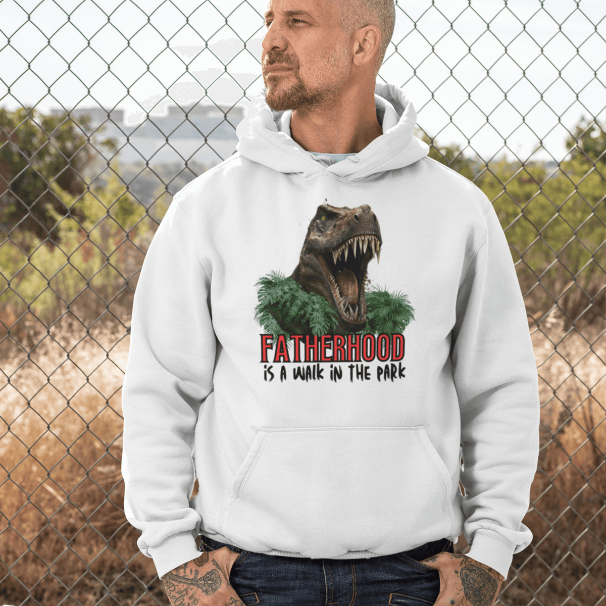 hoodie, dinosaur, fatherhood, parenting, family, dad life, cozy wear, graphic design, father's day, gift for dad, comfortable, unique phrase, casual style, warmth, versatile, soft fabric, empowerment, adventure, dad pride, loungewear, fashionable, quality, durability, fatherhood is a walk in the park tee